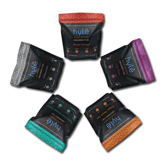 5 bags of hyle hydration endurance fuel arranged in a circle. Hyle Hydration Endurance Fuel is a powdered sports drink mix with carbohydrates, electrolytes, and amino acids.